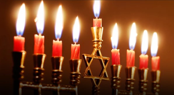 A lit Jewish Menorah with the Star of David